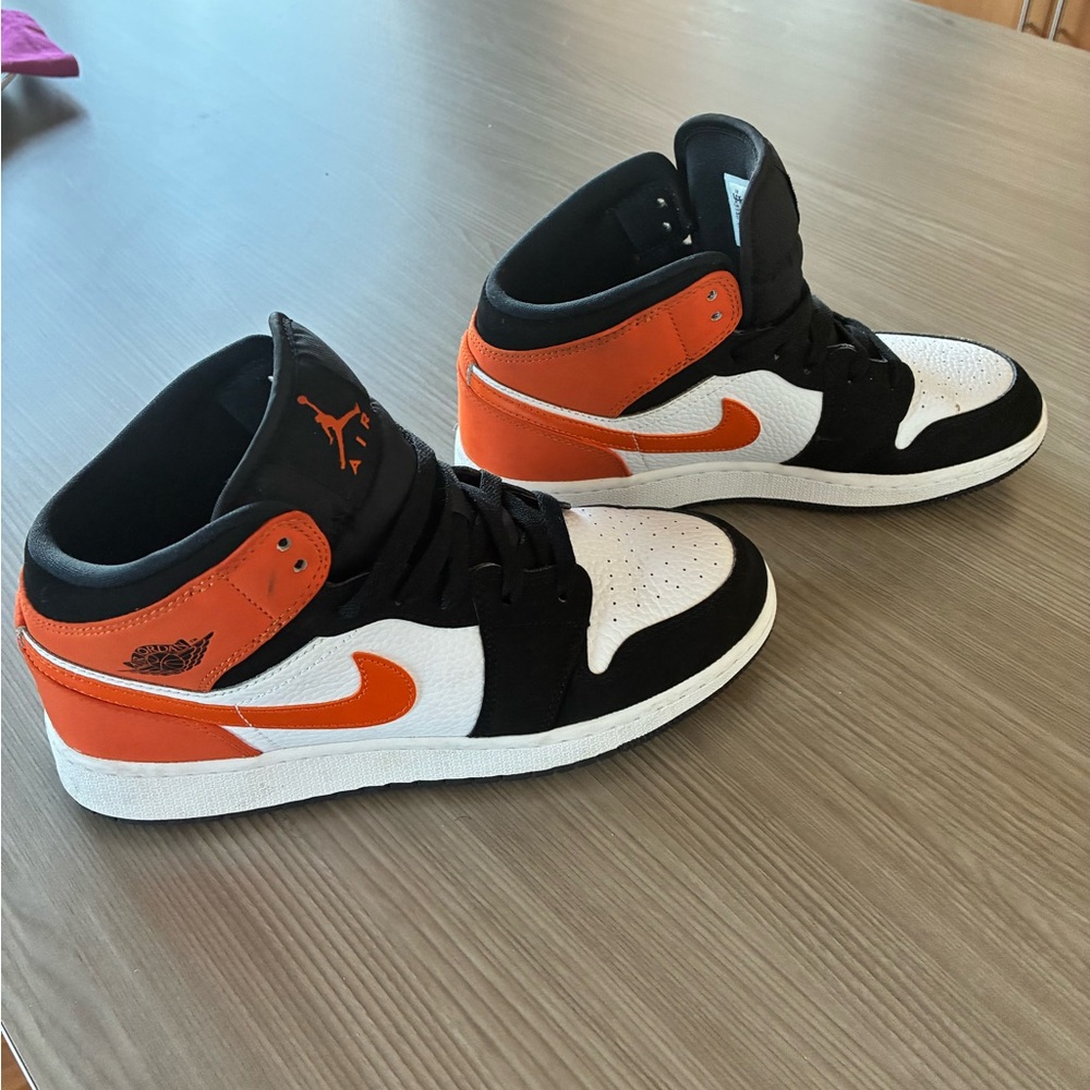 Nike Air Jordan Black, Orange, and White Sneakers